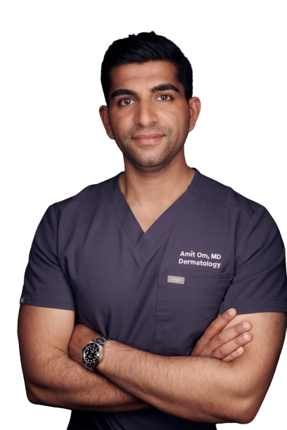 Dr. Amit Om in surgical scrubs, arms crossed