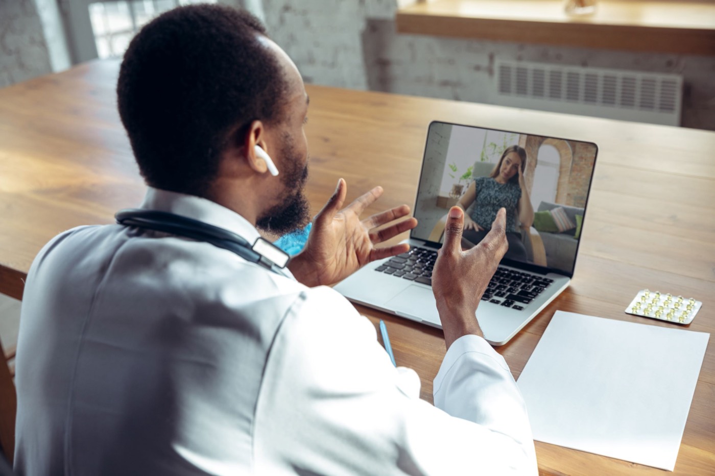 Physician conducting a telemedicine visit on a laptop